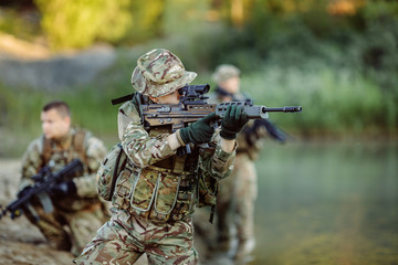 Fototapeta premium Special forces soldiers with weapon take part in military maneuv
