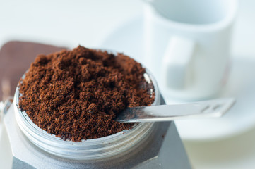 Italian coffee with ground coffee and a cup
