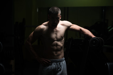 Fototapeta na wymiar Shoulder Exercise With Dumbbell In Dark Room