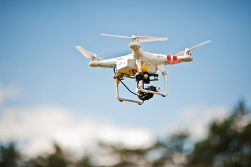 Fototapeta na wymiar Drone quad copter with high resolution digital camera flying in