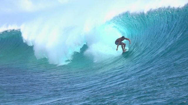 SLOW MOTION: Extreme surfer surfing inside big tube barrel wave