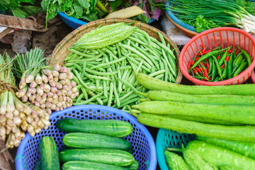 Asian street market selling pepper pea cucumber and onion