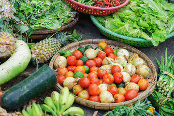 Asian street market selling tomato lime onion lettuce and ananas