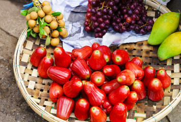 Asian street market selling rose apple longan grape and mango