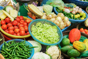 Asian street market selling tomato pepper cabbage and onion