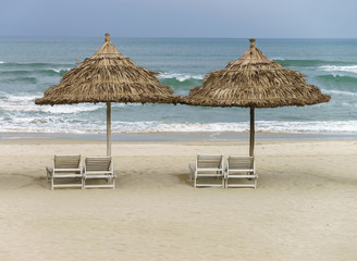 Palm shelter and sunbeds at the China Beach