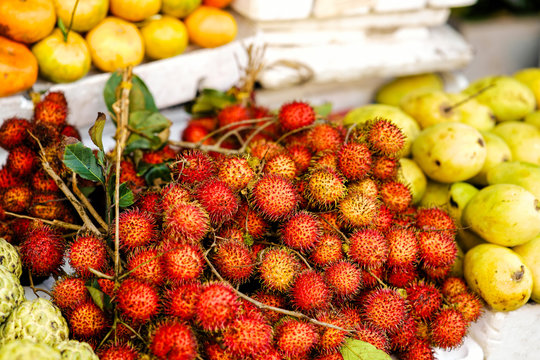 Asian street farmer market selling riped rambutan in Vietnam