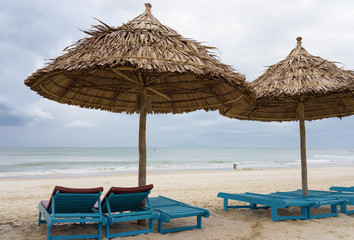 Sunbeds and Palm shelters in China Beach in Da Nang