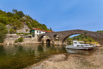 Fototapeta na wymiar Old Bridge in Rijeka Crnojevica River near Skadar Lake - Montene