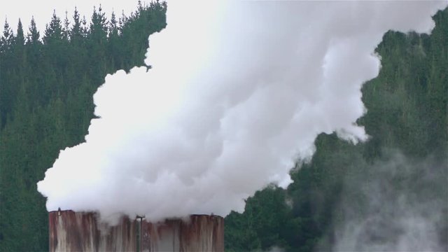CLOSE UP: Smoke and steam coming out of heating plant pipeline chimney
