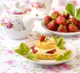Cream puffs or profiterole filled with whipped cream,g served with strawberries