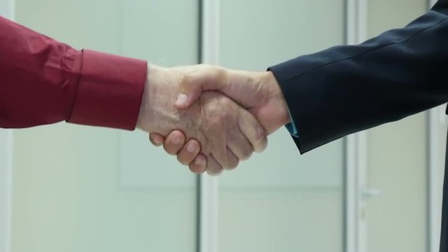 Business people shaking hands, finishing up a meeting slow motion