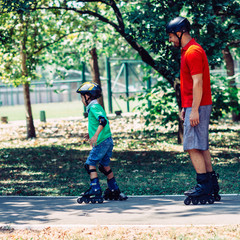 Roller blading father and son