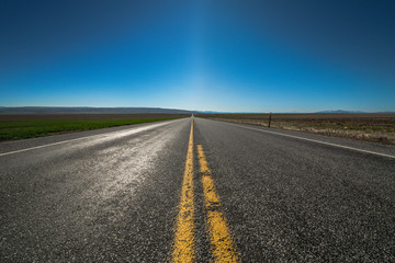 American highway horizon, lonely road and field.