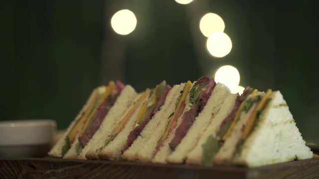 Sandwiches set rotate on a board. Close up