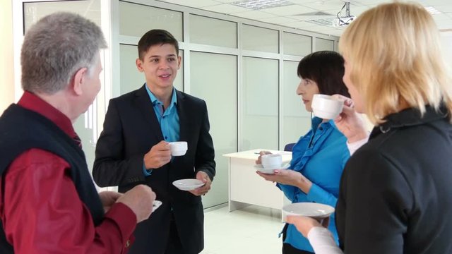 Business people drinking coffee at a conference in the office
