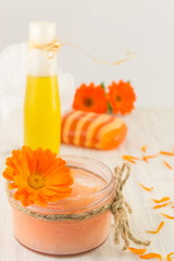 marigold cosmetics products with fresh flower bouquet