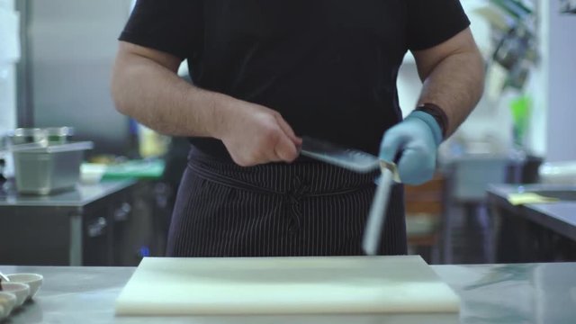 Chef sharpens kitchen knife