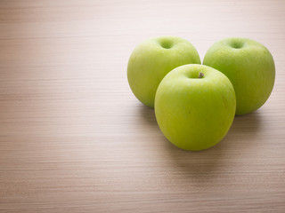 Apples with tape measure on blue wood background, lose weight concept