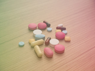 Pharmacy background on a wood table.Pills. Medicine and healthy. Close up of capsules. Different kind of medicines,Color Filter