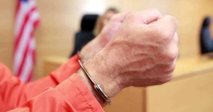 Close up of a criminal hands with handcuffs