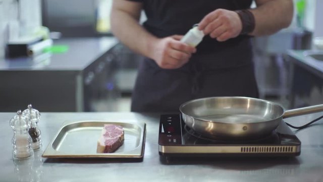 Chef preparing beef steak at kitchen in a restaurant