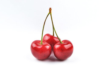 three cherries on a white background