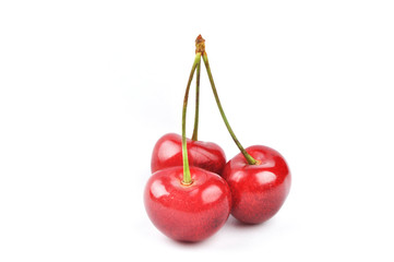 three cherries on a white background