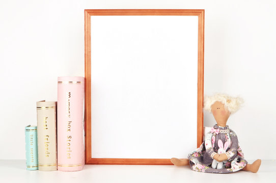 wooden picture frame with decorations. Mock up for your photo or text Place your work, print art,shabby style, white background, paper ball, toy, pastel color book