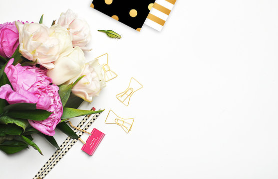 Peonies and gold. Office desktop. Flat lay. Glamour style. Stationery on white background. Flat lay