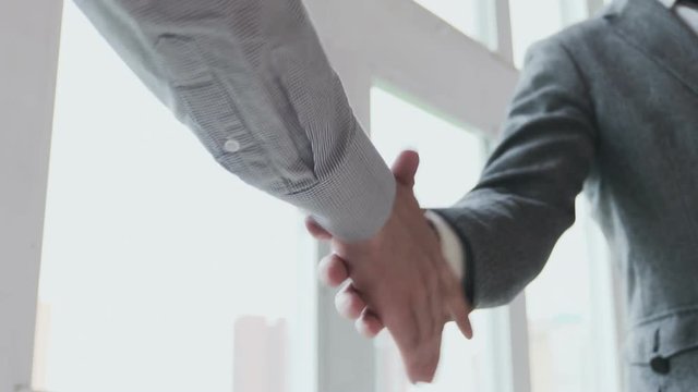 Business partners handshaking. Slow motion