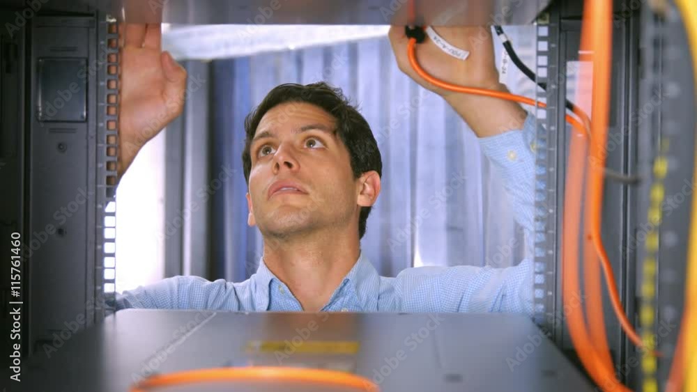 Poster technician looking at open server locker