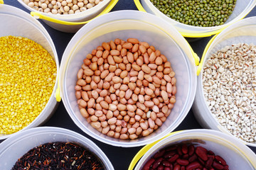 Fototapeta premium Mixed beans and lentils of different legumes on black background