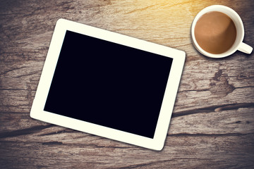White Tablet. Tablet pc and coffee cup on wooden table