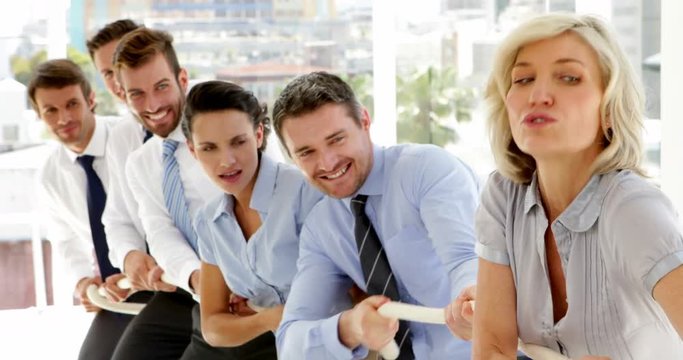 Business people pulling a rope with effort