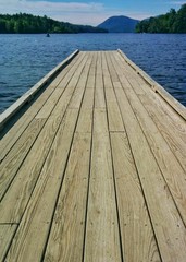 Quiet wood walkway on lake on clear summer day
