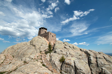 Harney Peak Fire Lookout Tower with stone steps leading down to pumphouse in Custer State Park in the Black Hills of South Dakota USA