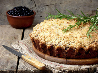 Homemade blueberries crumble pie on a wooden background