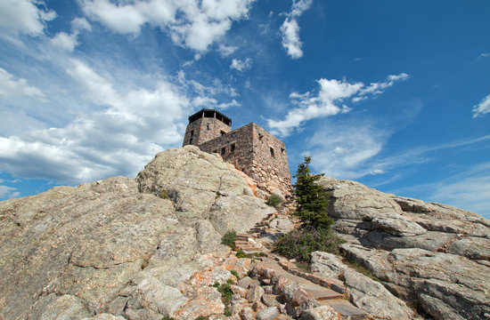 Harney Peak Fire Lookout Tower under cirrus cumulus cloudscape in Custer State Park in the Black Hills of South Dakota USA