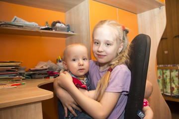 Young girl and her brother in the room