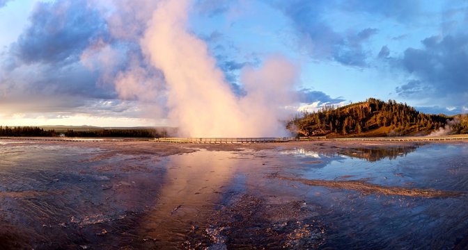 Geyser at sunset. Midway Geyser Basin of Yellowstone National Park, Jackson Hole, Wyoming, USA. 