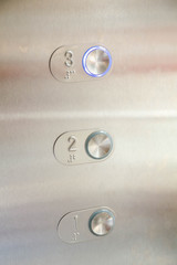 Close-up Elevator Pressing. Modern Metal . button. businessman is a lift.