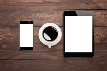 phone tablet and coffee cup on wood table top view - Powered by Adobe