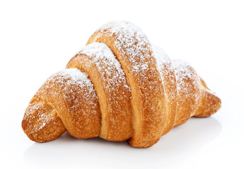 Croissant covered with sugar powder, isolated on a white backgro