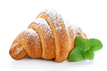 Croissant covered with sugar powder, isolated on a white backgro