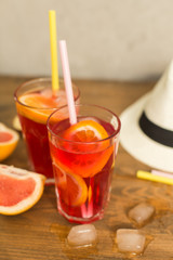 two glasses of fruit drink blackcurrant with hat on table