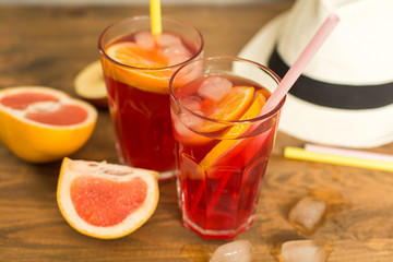 two glasses of fruit drink blackcurrant with hat on table