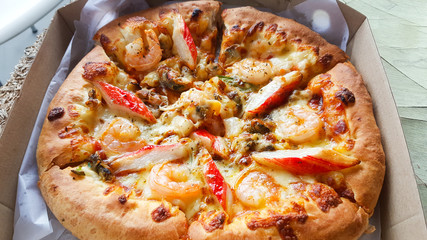 Pizza with seafood  delicious in delivery box