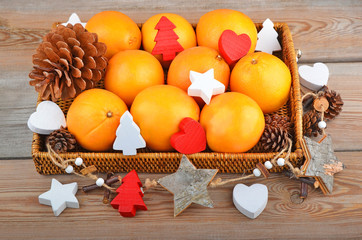 Orange in wickered tray with Christmas decor