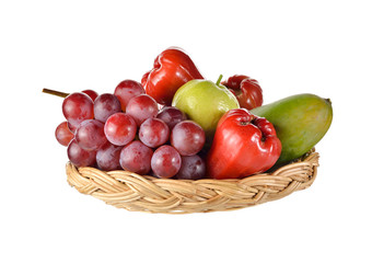 mixed fruits in rattan basket on white background